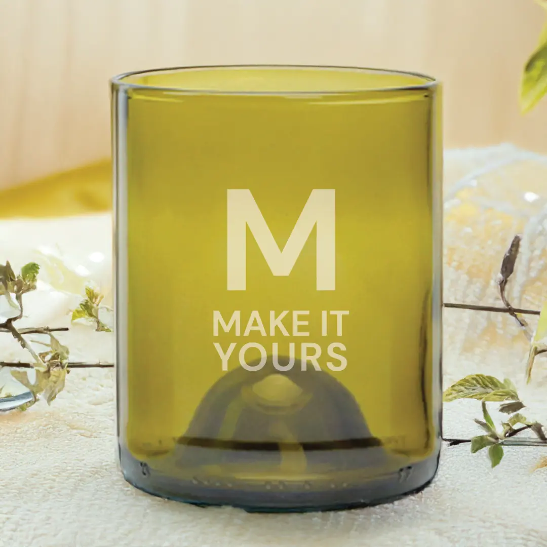 glass tumbler resting on table and surrounded by leaves