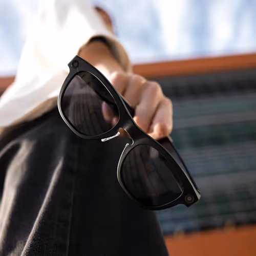person gripping smart glasses in their hand