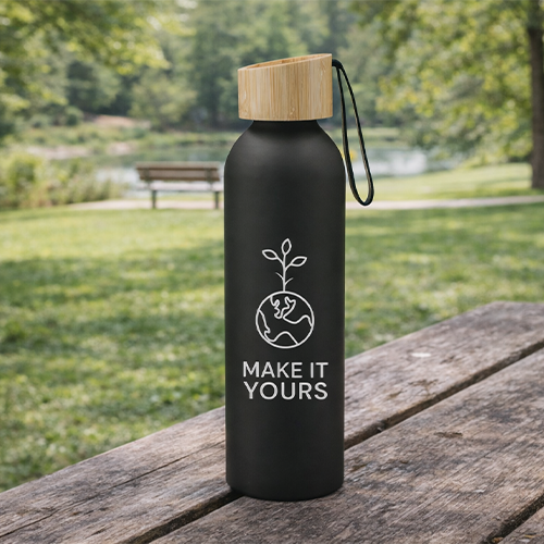 black water bottle sitting on picnic bench in a park setting