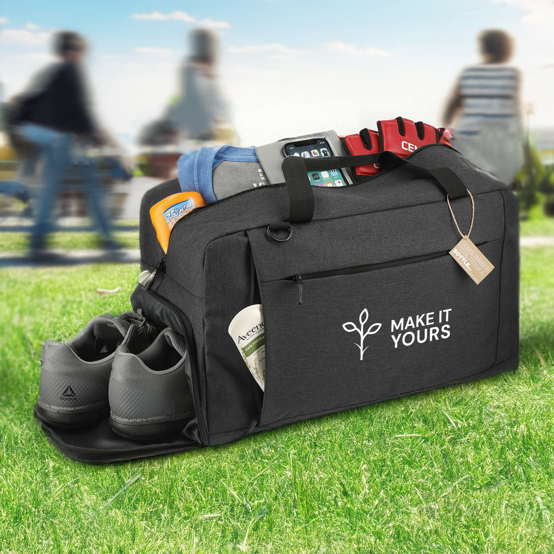 travel duffel filled with golf shoes, towels, golf gloves sitting on a golf green