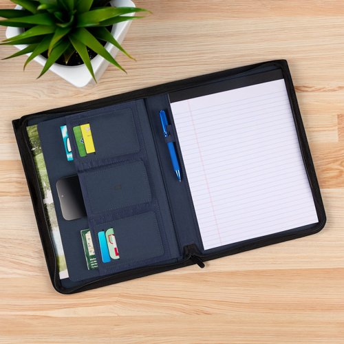 zippered portfolio on wooden desk beside potted plant