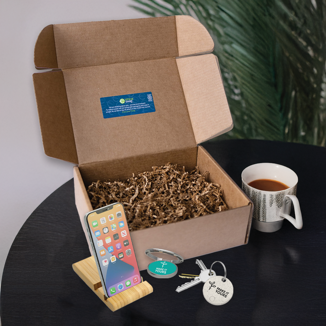 swag pack containing various tech items resting on table beside tea mug