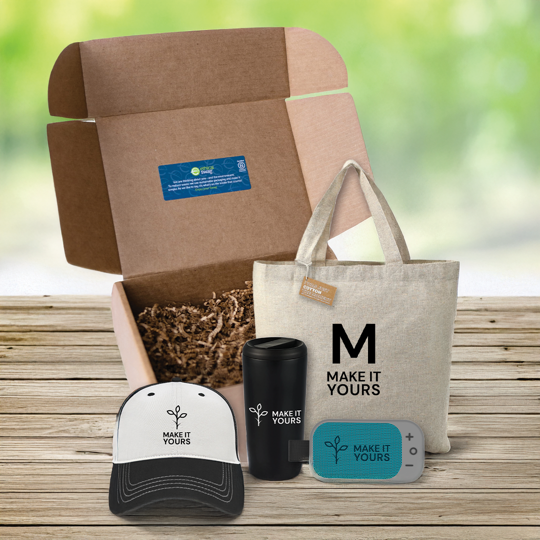 swag pack sitting on wooden picnic table containing tote bag, water bottle, bluetooth speaker and hat