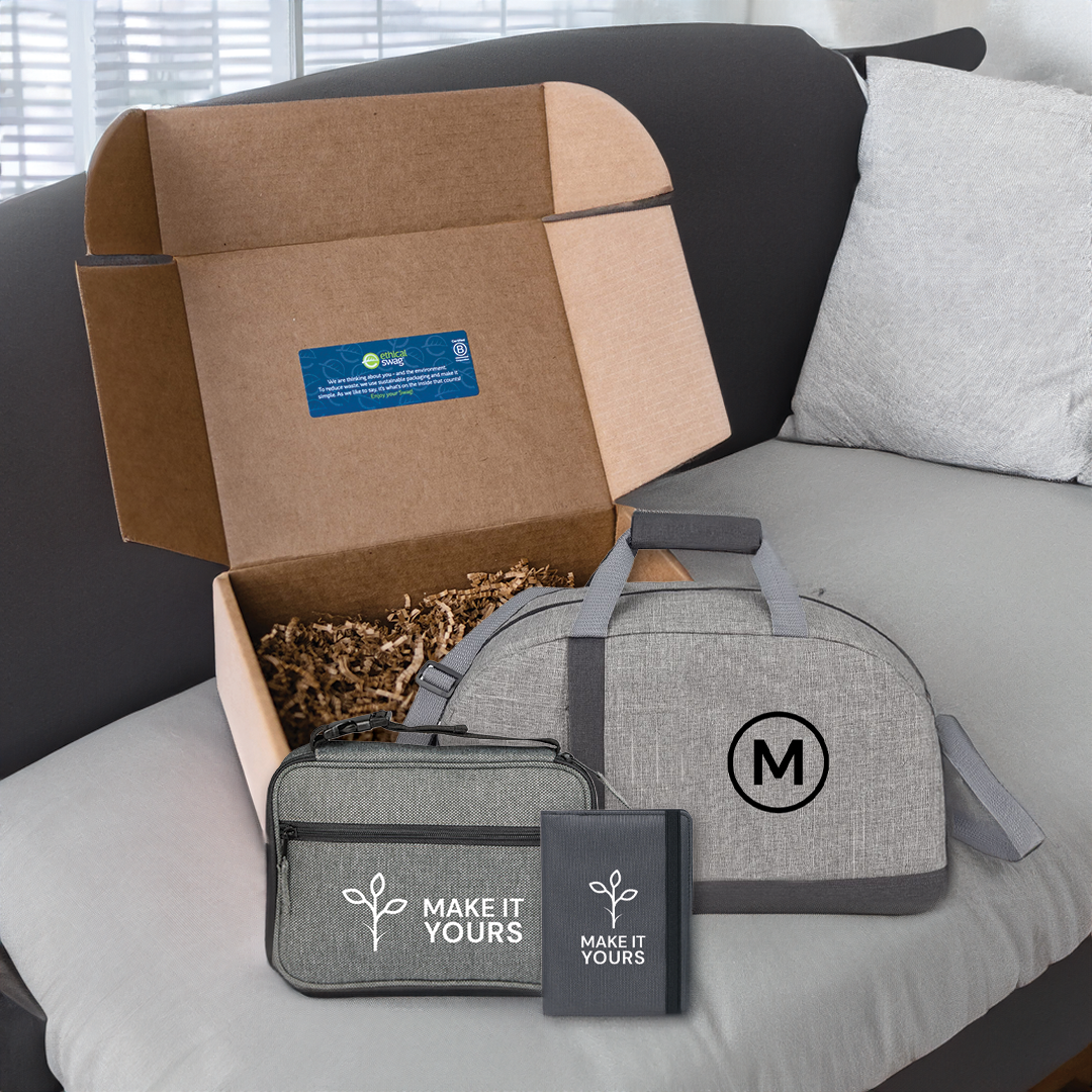 swag pack sitting on couch containing travel bag, accessory travel bag, and passport holder