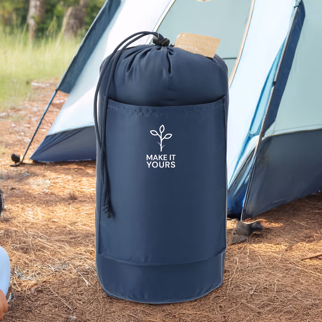 a blanket rolled up inside sleeve and sitting on a campground beside tent