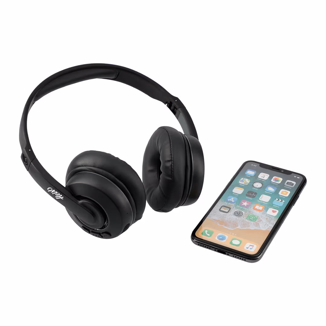 branded earmuff headphones resting beside smartphone