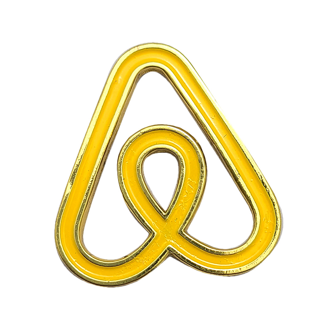 soft enamel pin of airbnb logo in yellow