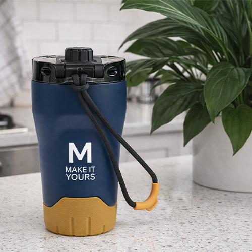 tumbler resting on granite counter with potted plant