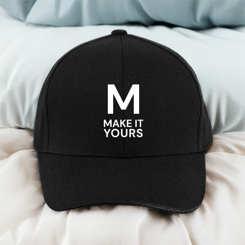 black branded hat resting on bedsheets 