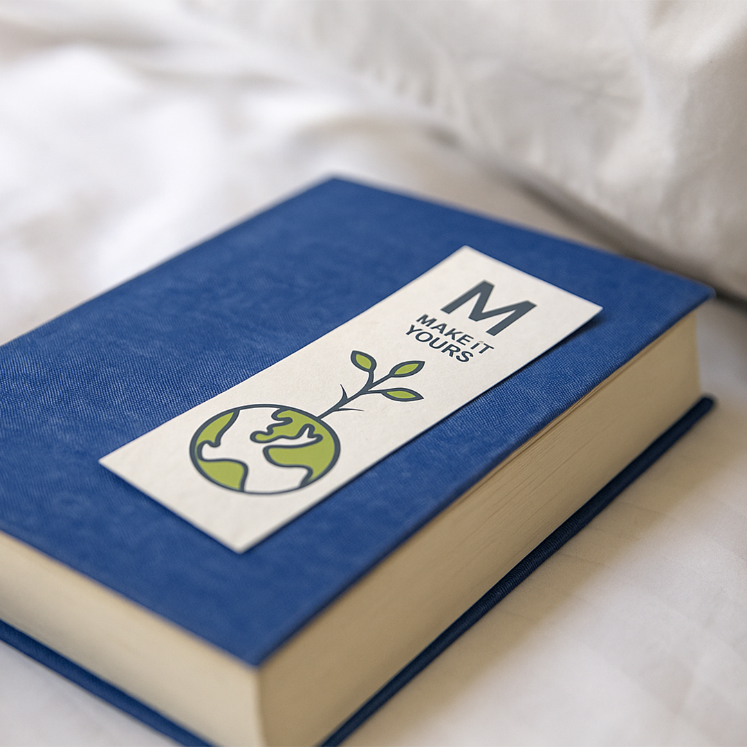 a seed paper bookmark resting atop blue book